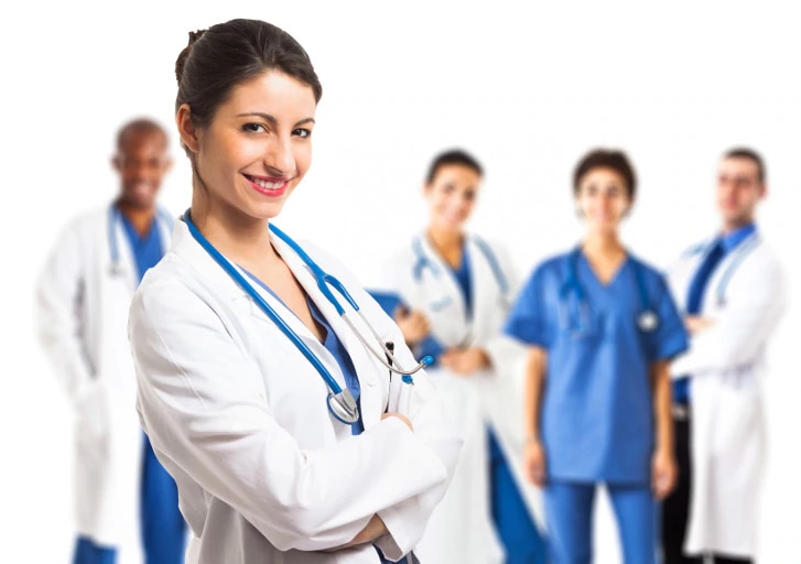 Portrait of a beautiful smiling doctor in front of her team