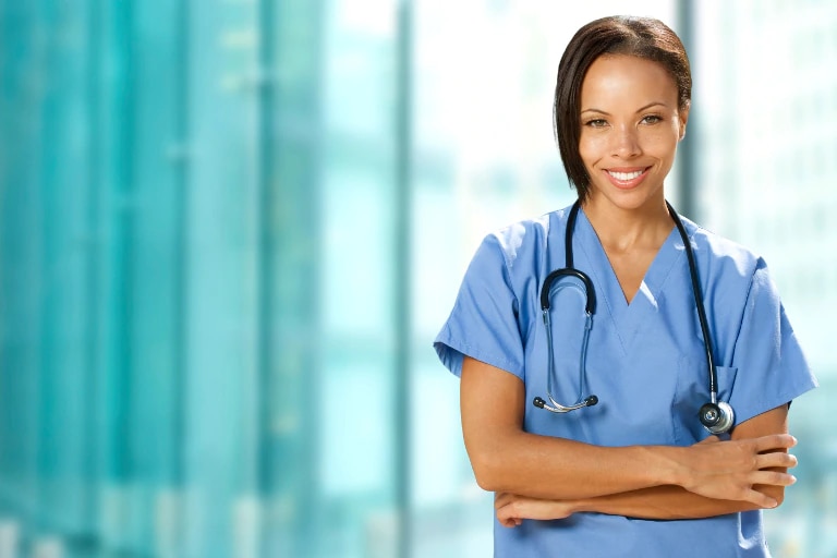 young female healthcare professional photographed in hospital corridor.